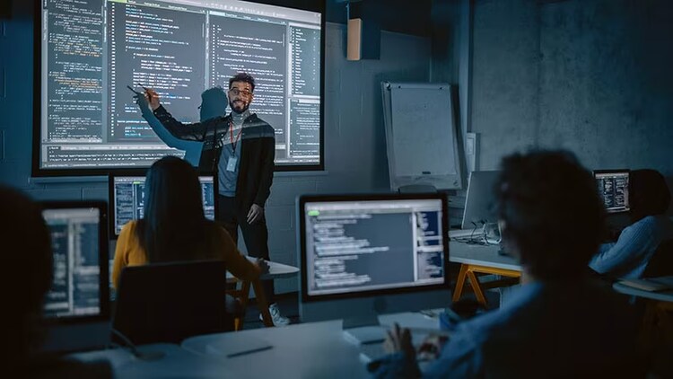 Technology in higher education: Teacher in front of board at head of class