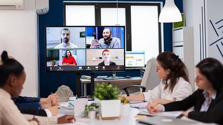 Future workplace: Gathering with co-workers in person at the office and others virtually