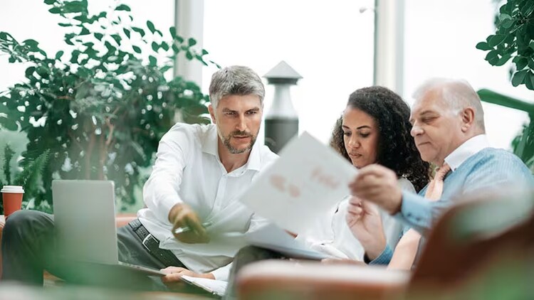 Customer journey mapping: 3 workers looking at papers
