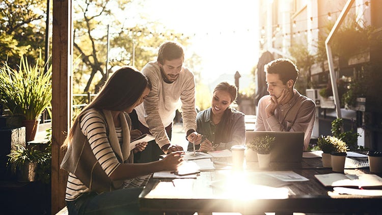 Italy’s digital economy: group of workers gathered around an outdoor table