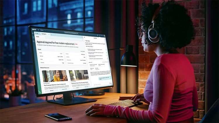 Agentic AI: woman sitting at a computer using ServiceNow Agentic AI features