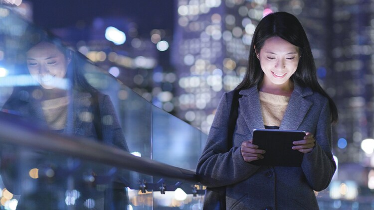 Human renaissance: woman smiling at a tablet in her hands