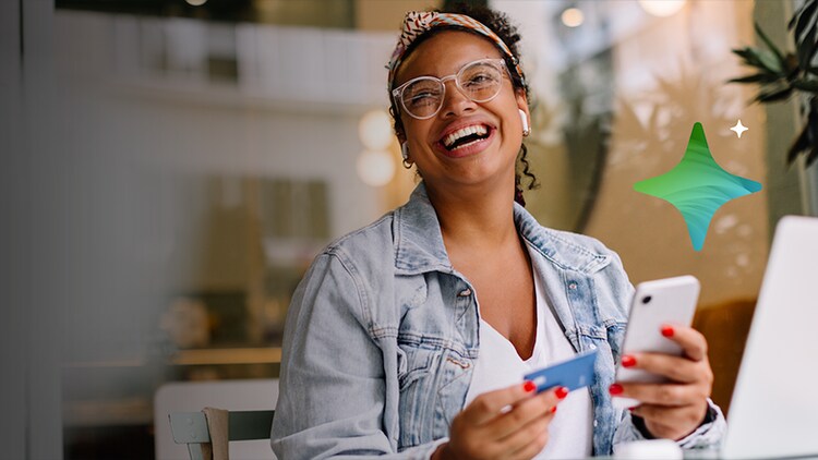 Banking transformation: woman laughing while holding a credit card and phone with a four-pronged star above it to represent AI