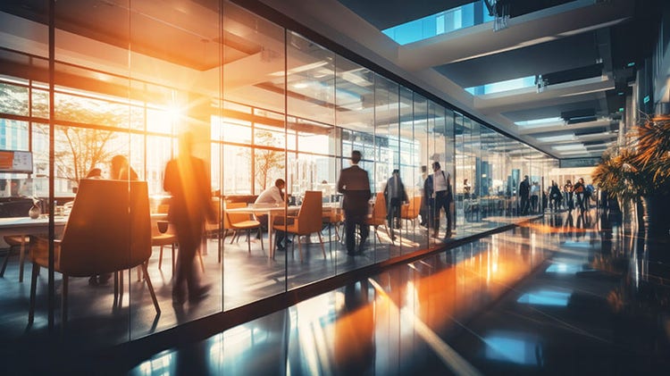 Busy office environment with the sun shining through