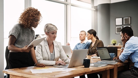 AI for HR: HR team collaborating using AI-powered tools in a modern office setting