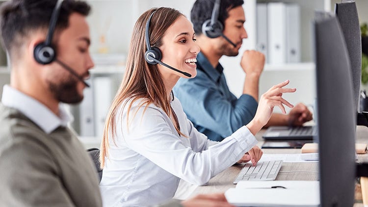 Customer service agents working online in an office
