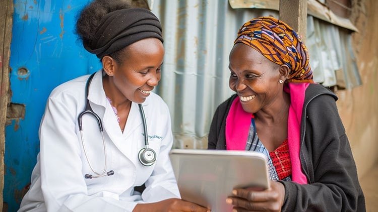 Healthcare worker and woman smiling at a tablet
