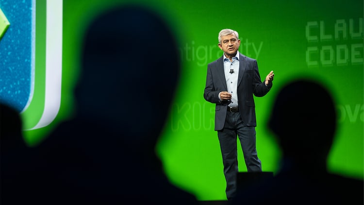 A view of Amit Zavery, ServiceNow president, CPO, and COO, through silhouetted heads